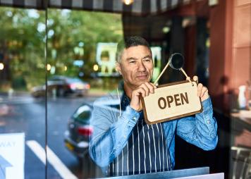 man opening store