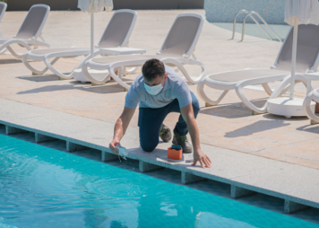 A man testing the PH levels at a pool