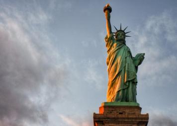 Portrait of Statue of Liberty against a blue gray sky 