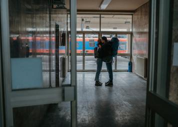 couple hugging at a train station