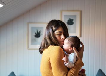 young woman holding a baby 