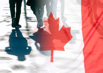 The National Flag of Canada and shadows of people