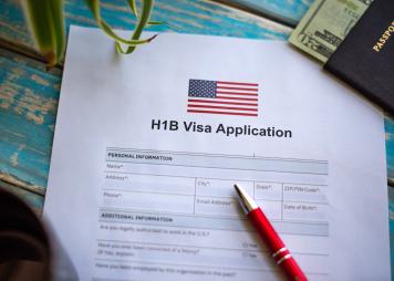 Illustrative picture showing application for United States of America work visa H1B with pen