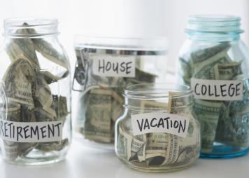 Close up of savings jars with money