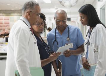 Doctors and nurses reviewing medical chart