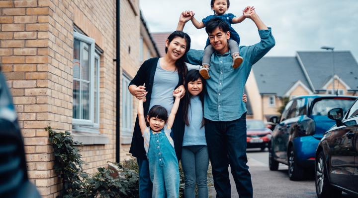 Asian family standing together, mom, dad, and three kids