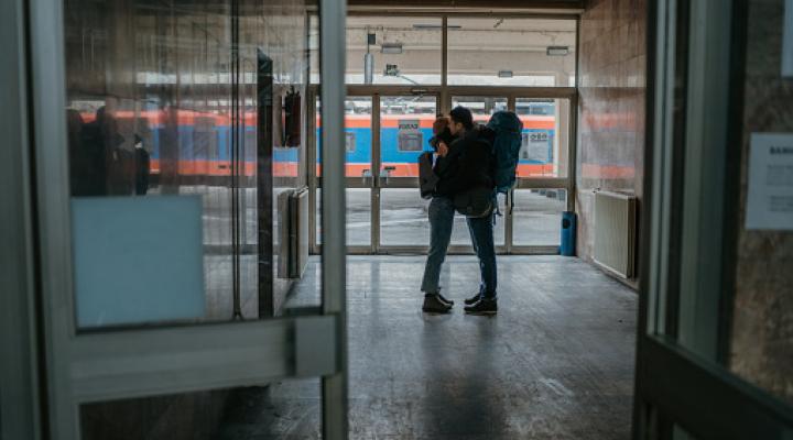 couple hugging at a train station