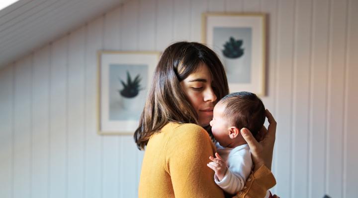 young woman holding a baby 