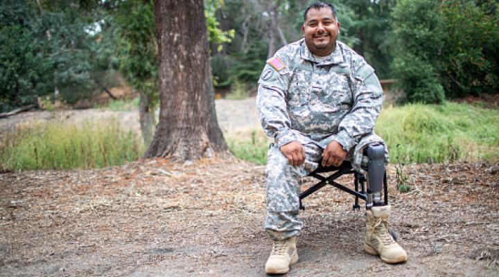 A Hispanic army veteran with his wheelchair in uniform