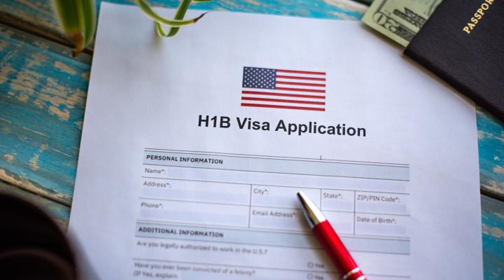 Illustrative picture showing application for United States of America work visa H1B with pen