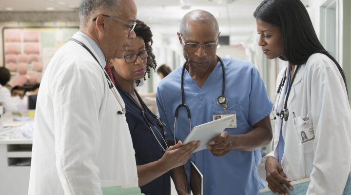 Doctors and nurses reviewing medical chart